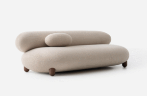 Cream bouclé lounge sofa with rounded bolsters — NOOM “Flock” — quiet, sculptural seating for a luxury yacht interior.