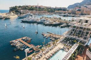 Aerial view of Monaco Yacht Club terraces and Port Hercule berths filled with yachts