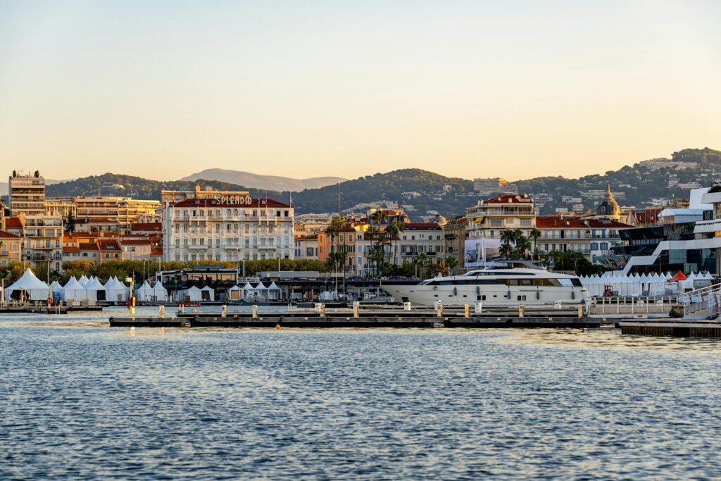 Cannes Vieux Port at sunset with a superyacht moored during the Cannes Yachting Festival