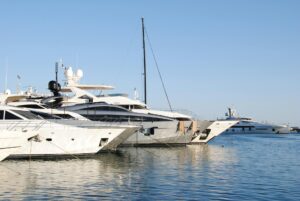 Superyachts docked in Cannes marina at golden hour during the yachting festival