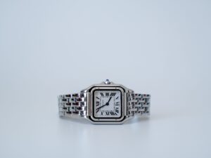 Classic stainless steel Cartier luxury watch illustrating refined yacht charter dress code and understated men's accessories.