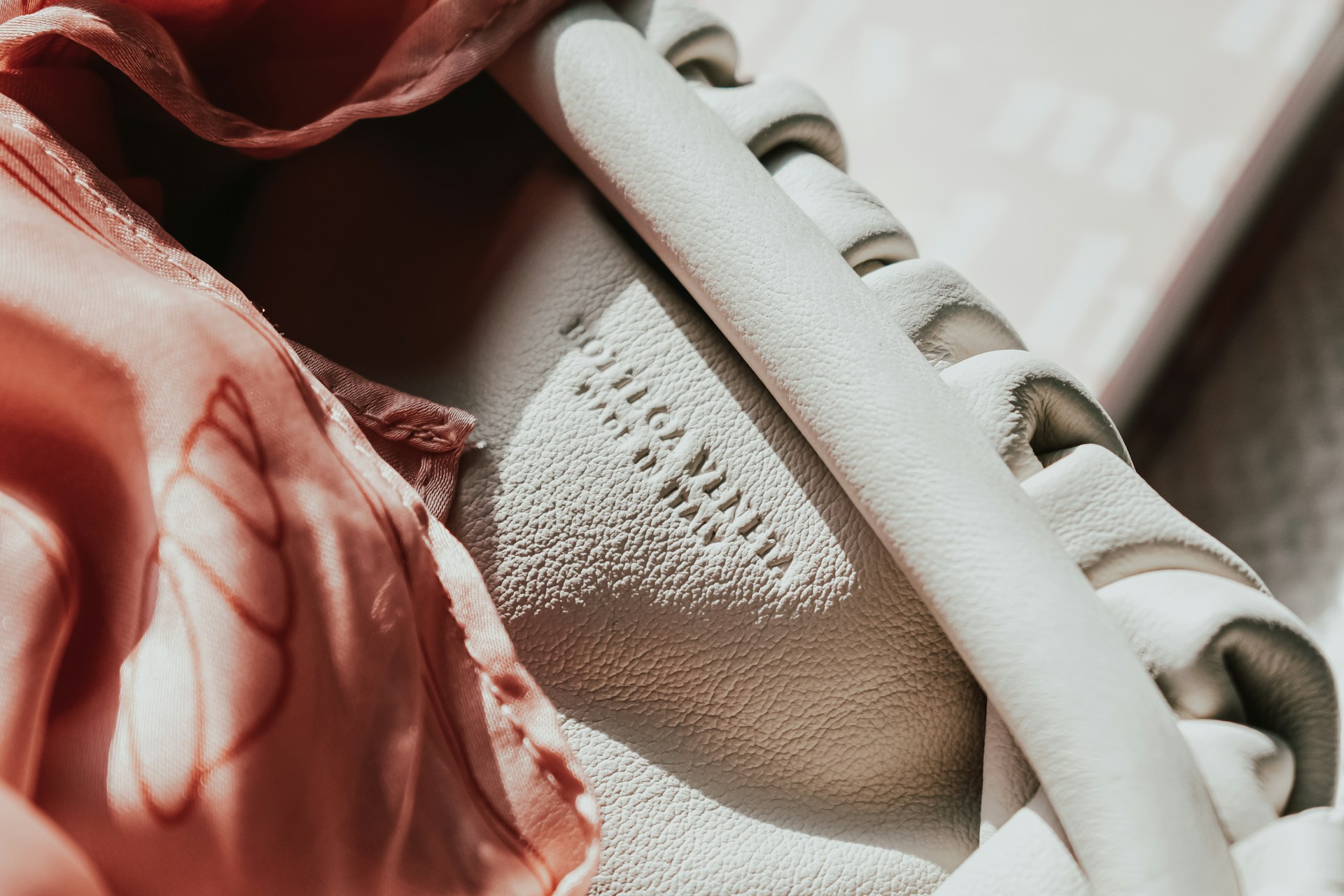Luxury handbag on the deck of a superyacht, reflecting refined yacht charter etiquette and elegant onboard style.