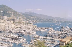 Superyachts docked closely in Monaco harbour during peak season berth congestion
