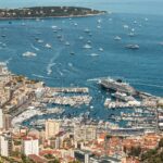 Superyacht berths in Monaco seen above Fontvieille Harbour, showing the limited marina space and surrounding cityscape