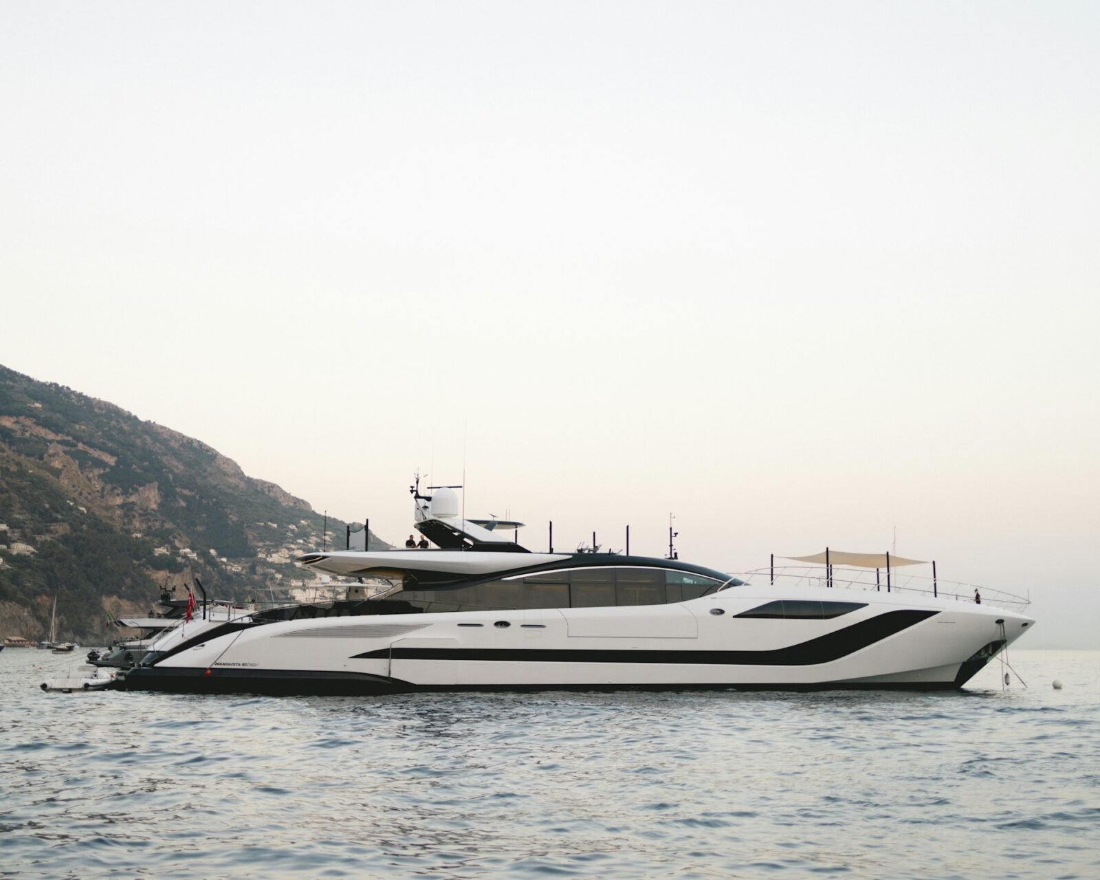 A quiet Mediterranean anchorage — where the hidden costs of yacht charter are created by operational choices, not the brochure price.