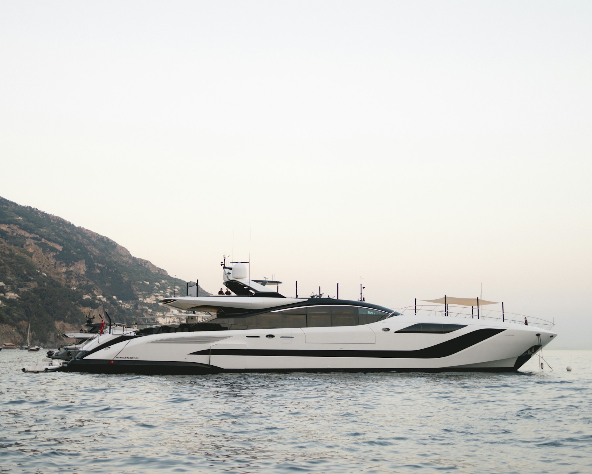 A quiet Mediterranean anchorage — where the hidden costs of yacht charter are created by operational choices, not the brochure price.