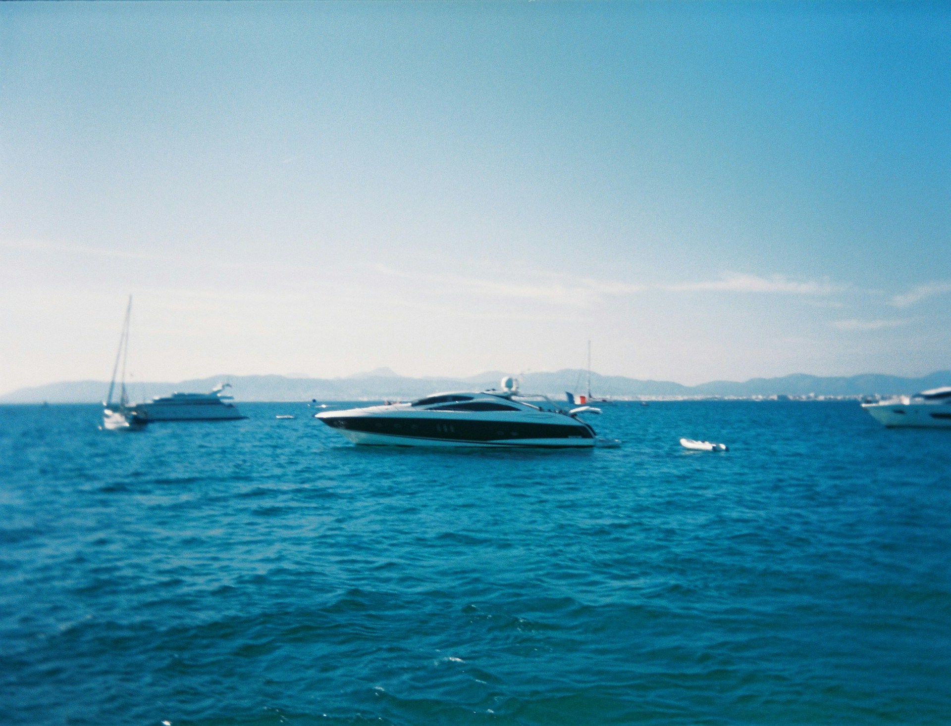 Quiet Mediterranean anchorage with charter yachts at rest, illustrating how much it costs to charter a yacht in the Mediterranean beyond the base price