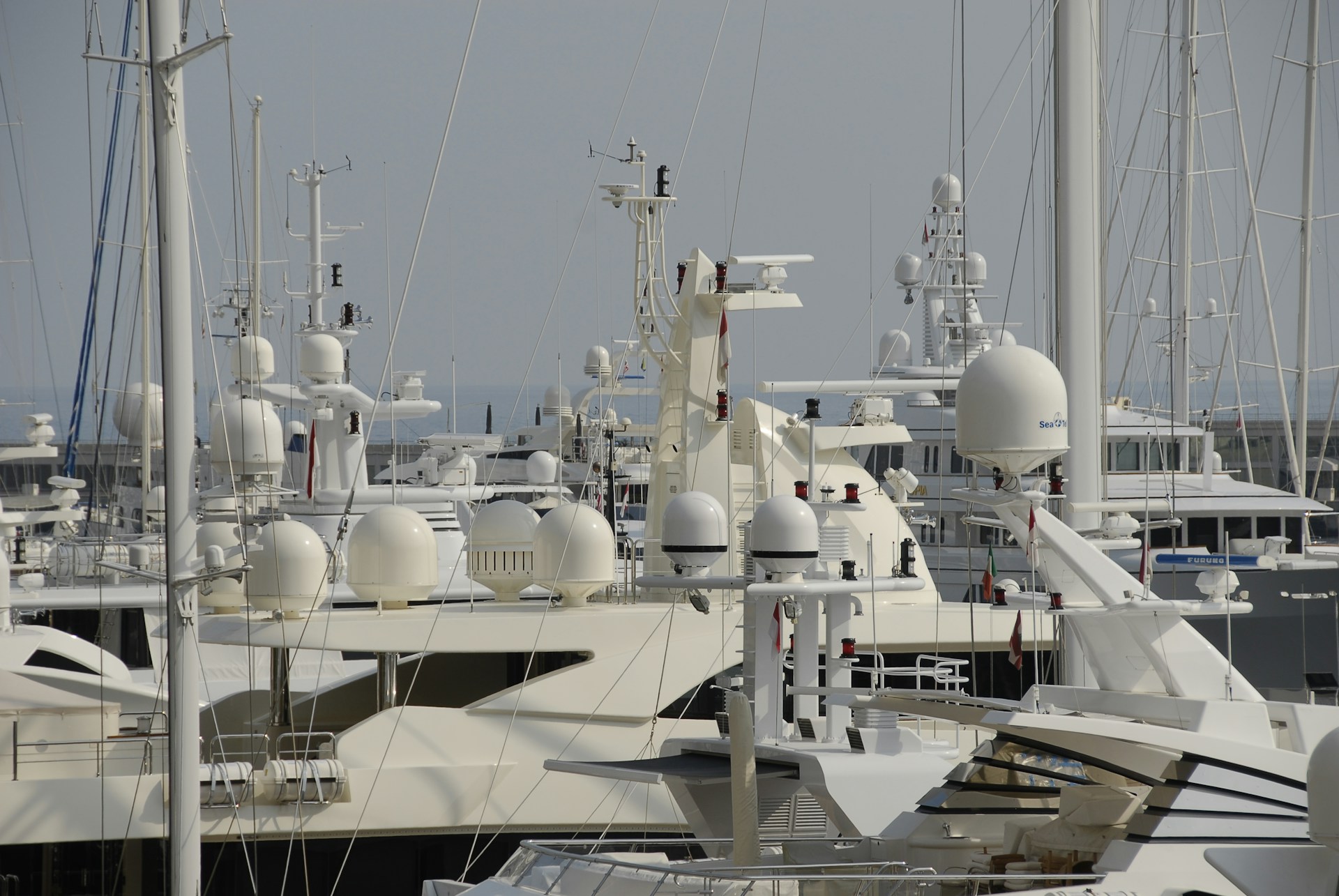 Superyachts moored in Port Vauban marina in Antibes during morning harbour activity