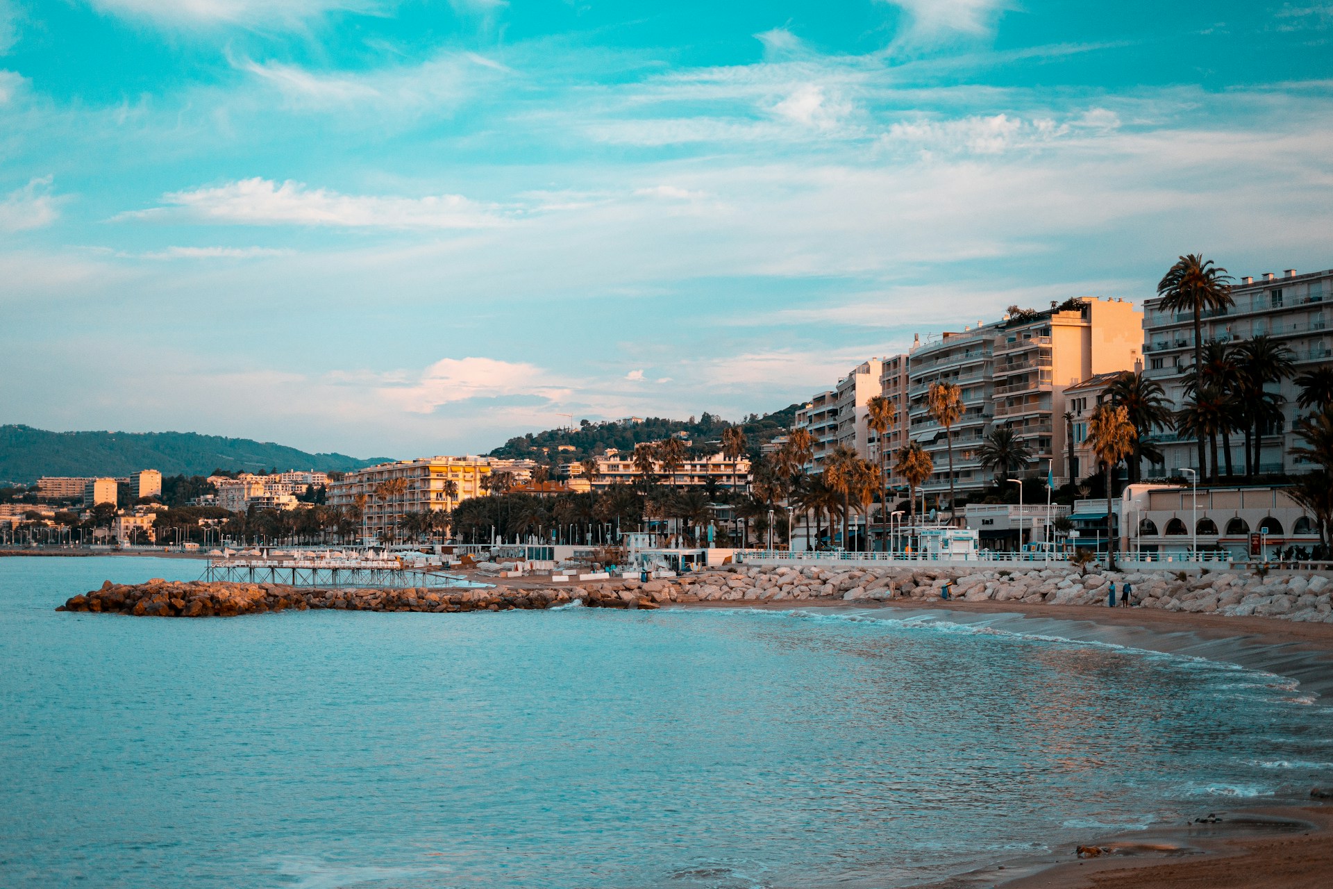 La Croisette promenade in Cannes with beachfront buildings and palm-lined coastline on the French Riviera