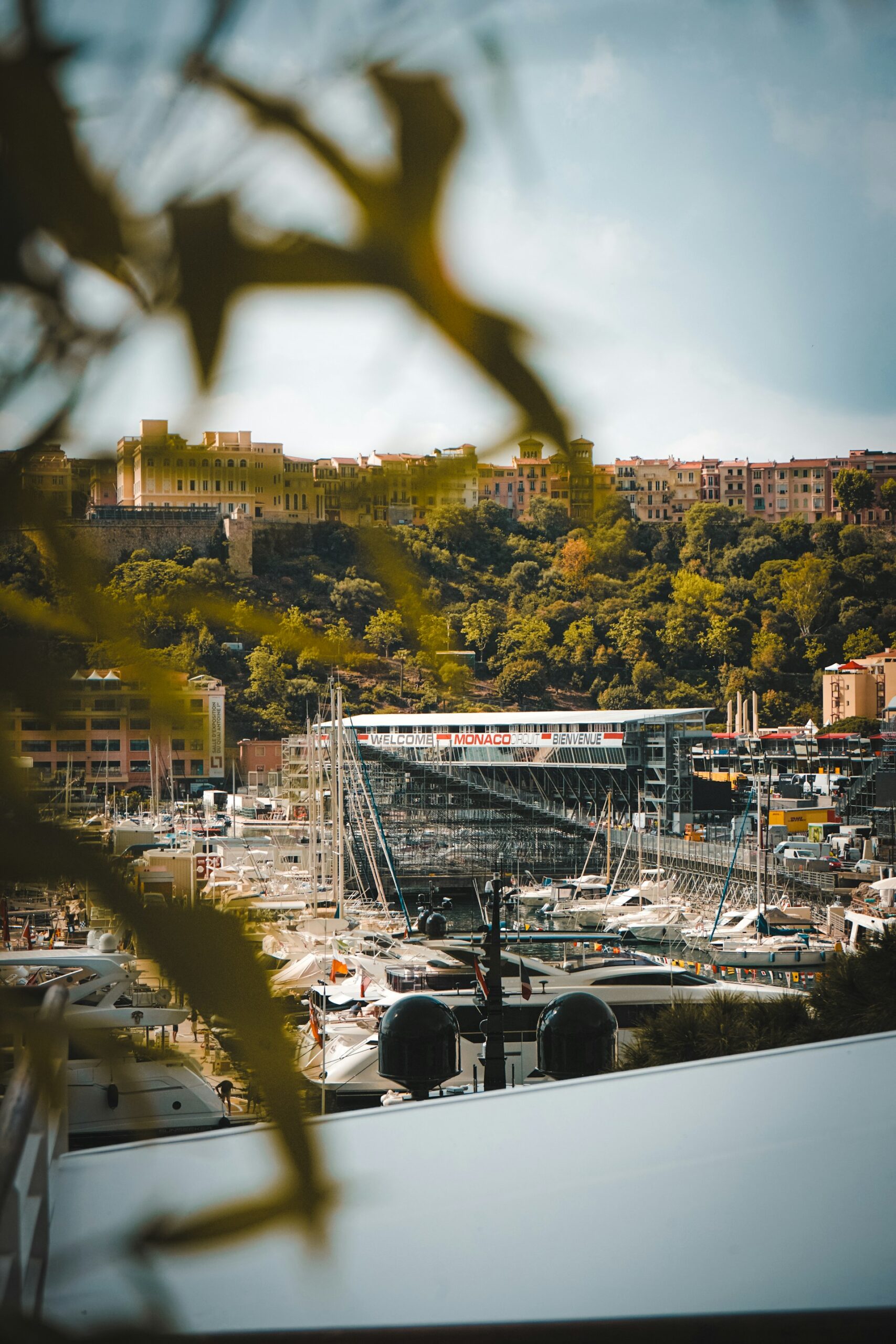 Port Hercule Monaco during Grand Prix setup with yachts, harbour infrastructure, and grandstand structures