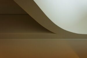 curved yacht interior architecture with soft light and shadow creating calm spatial flow