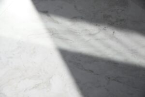 Natural marble surface with soft daylight and shadow illustrating material depth in luxury yacht stonework.