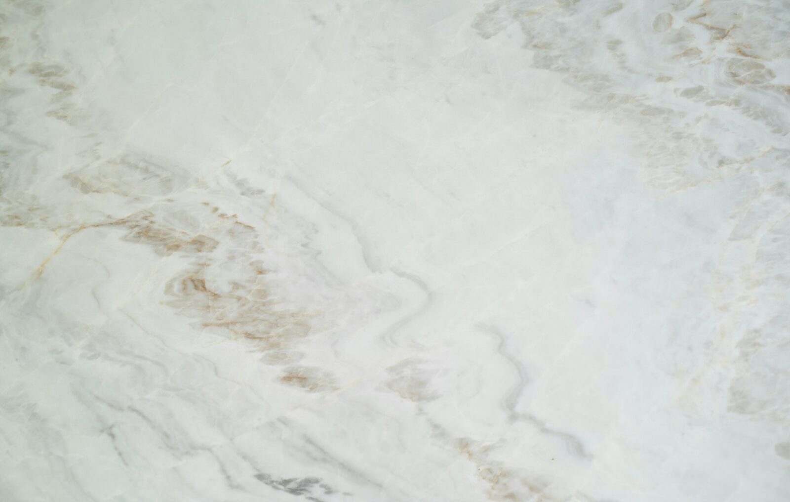 Natural marble slab with soft grey and warm veining illustrating yacht stonework in a luxury yacht interior.