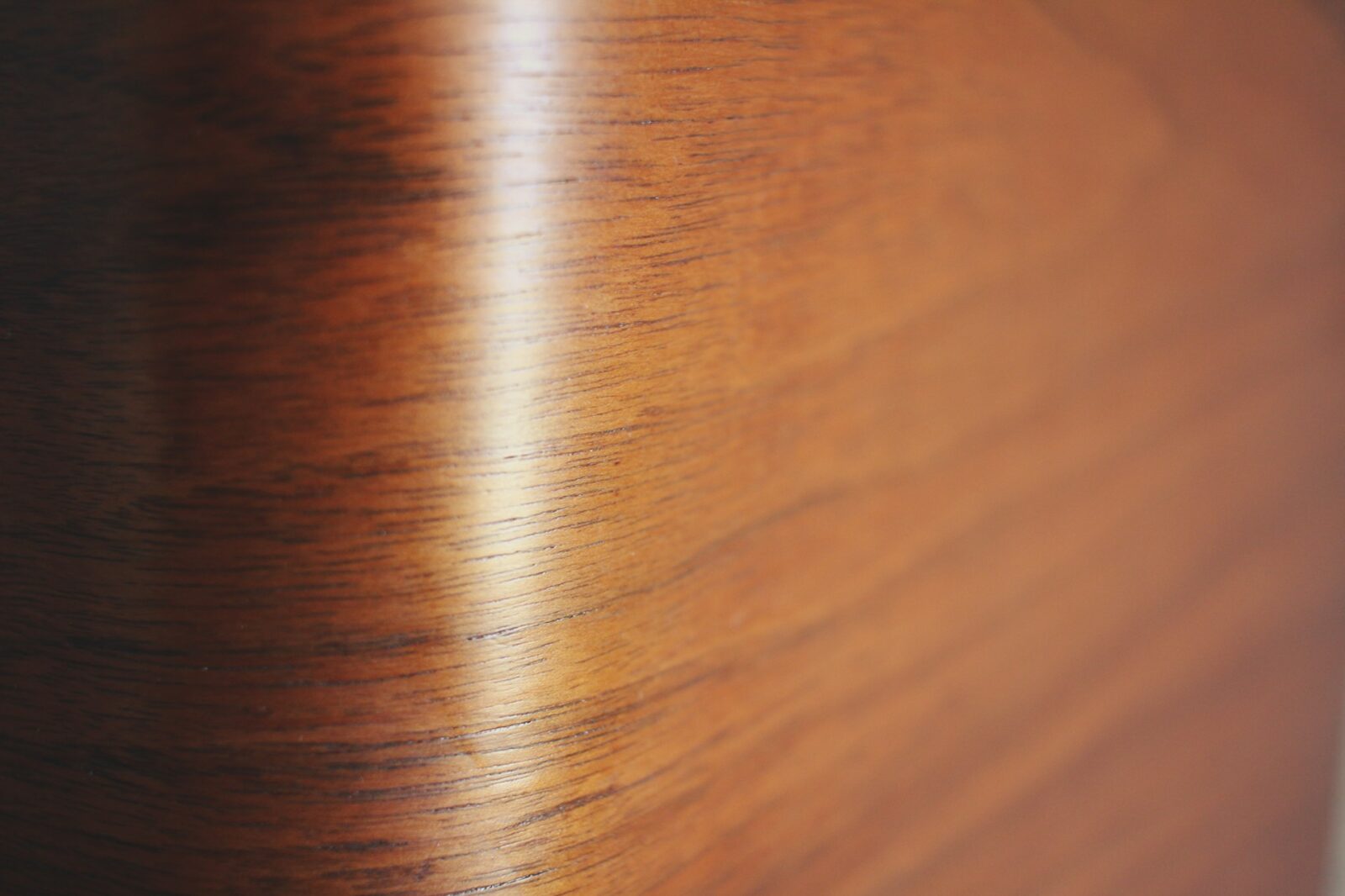 Walnut wood finish detail showing grain texture and surface reflection in a luxury yacht interior