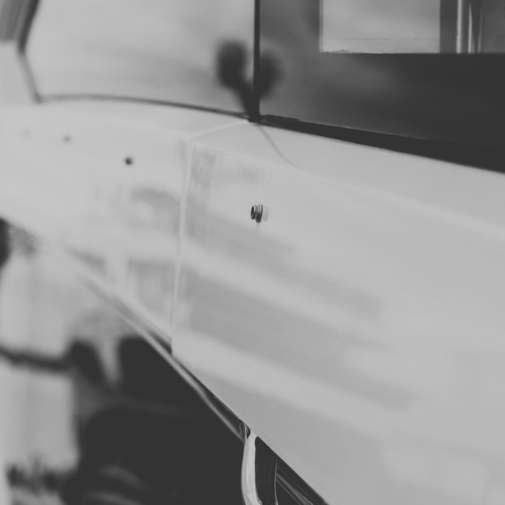 Close-up of yacht exterior detailing with dark glass and polished stainless-steel hardware