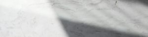 Natural marble surface with soft daylight and shadow illustrating material depth in luxury yacht stonework.